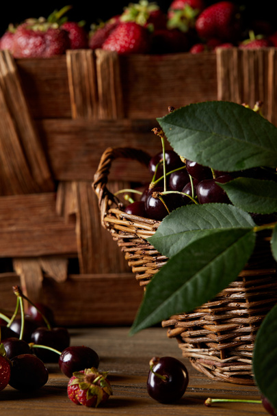 close-up shot of cherries and strawberries in basket and box - Фото, изображение