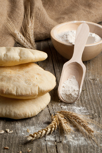 Pita bread with ears and flour - Zdjęcie, obraz