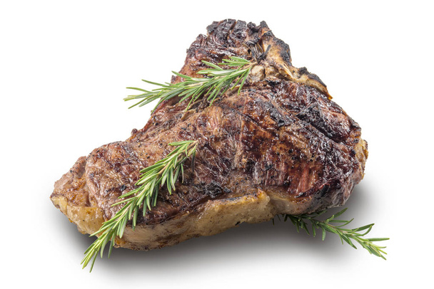 Whole grilled T-bone steak with rosemary isolated on white background - Photo, Image