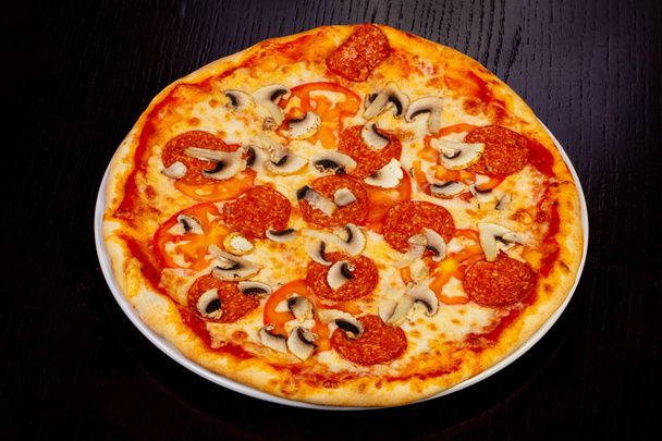 Deliciosa pizza de pepperoni con champiñones
 - Foto, imagen