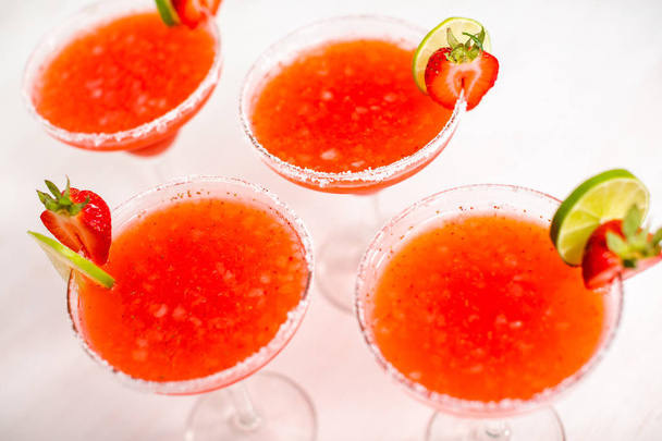 Fresh Strawberry margarita cocktail garnished with fresh strawberry and lime. - Photo, Image