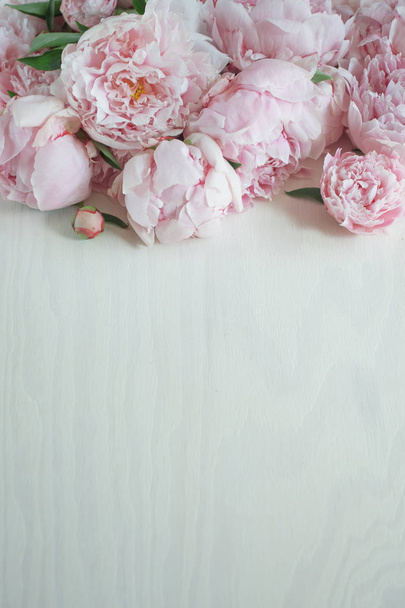 Flat lay concept with beautiful peonies on white wood, can be used as background - Фото, изображение