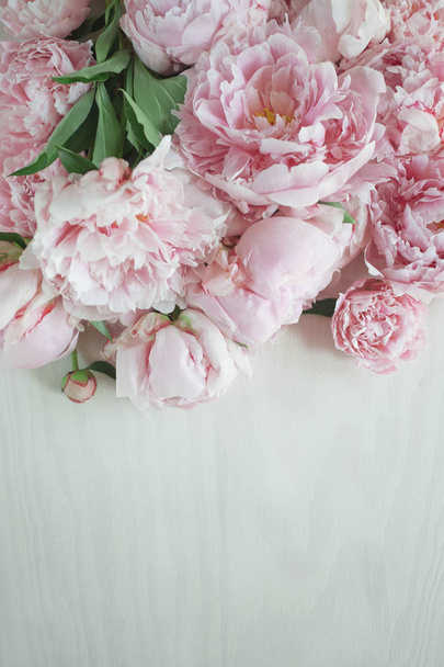 Flat lay concept with beautiful peonies on white wood, can be used as background - Foto, afbeelding