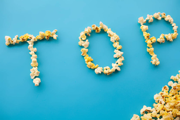 Food. Word Top. Popcorn bucket. Delicious Popcorn on Blue Background. Cinema. - Fotoğraf, Görsel