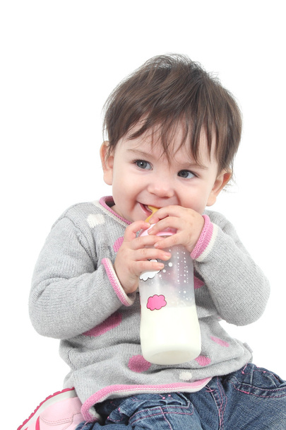 Baby with a feeding bottle in her mouth - Φωτογραφία, εικόνα