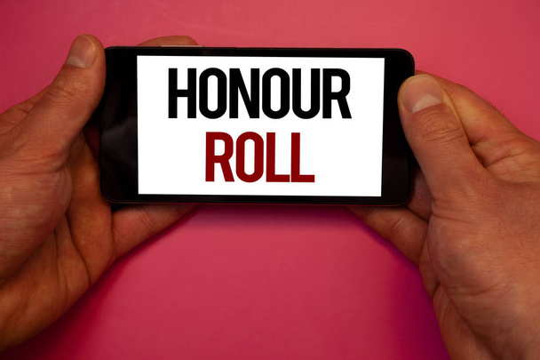 Conceptual hand writing showing Honour Roll. Business photo showcasing List of students who have earned grades above a specific averageMan hold holding cell phone white screen black red letters - Photo, Image
