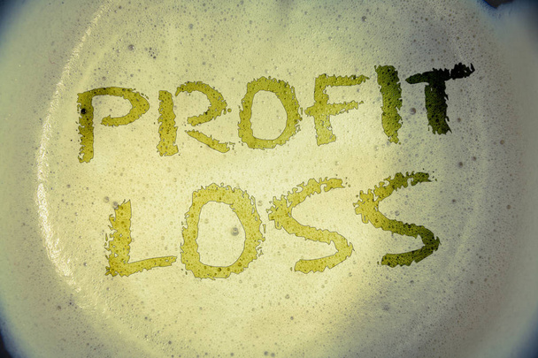 Writing note showing  Profit Loss. Business photo showcasing Financial year end account contains total revenues and expensesIdeas messages concepts words letters created foamy coffee background - Photo, Image