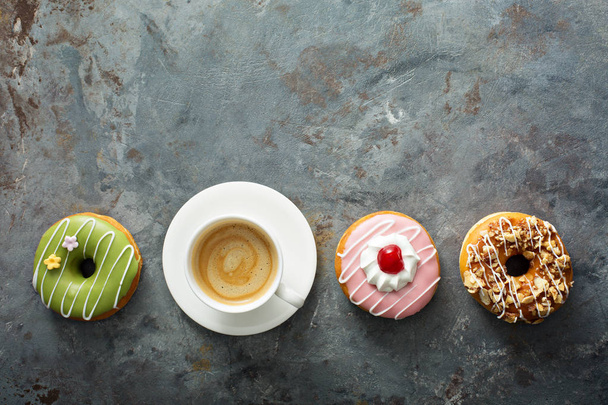 Sweet donuts with coffee overhead view - Foto, afbeelding