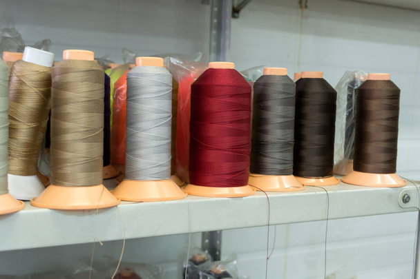 Bobbins with colored threads in the studio - Photo, Image