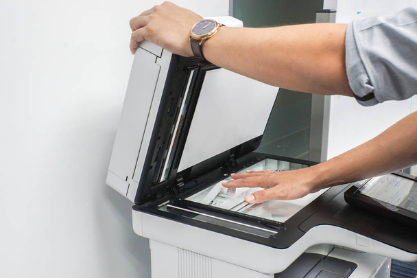 close up businessman lift the office printer plate to scanning preparation - Photo, Image