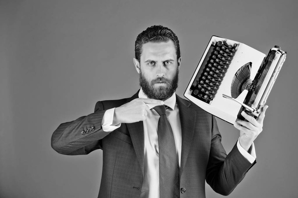 profession of a copywriter. business man in blue suit and tie with typewriter - Foto, imagen