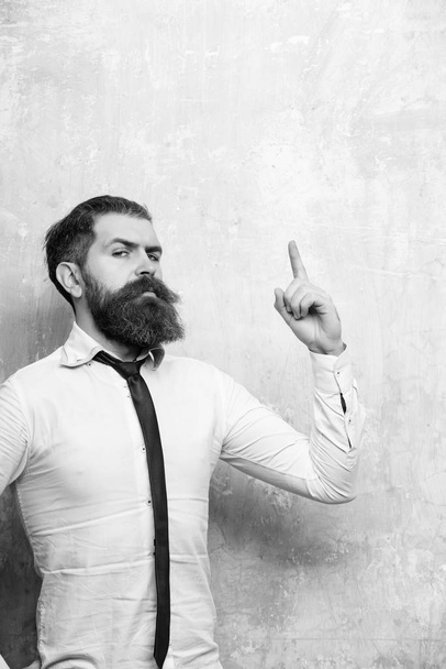 man Gives instructions. hipster or bearded man with long beard on serious face - Фото, зображення