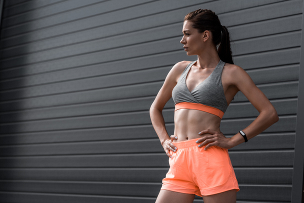 young sporty girl posing in sportswear with fitness tracker - Zdjęcie, obraz