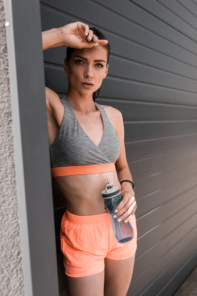 beautiful athletic woman holding sports bottle of water - 写真・画像