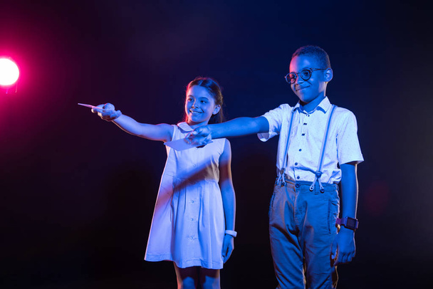 Pleased kids holding their remote controls - 写真・画像