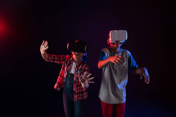 Exuberant kids wearing VR headsets - Foto, Imagen