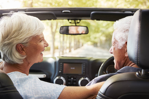 Senior Couple Drive Open Top Car On Countryside Road Trip - Photo, image