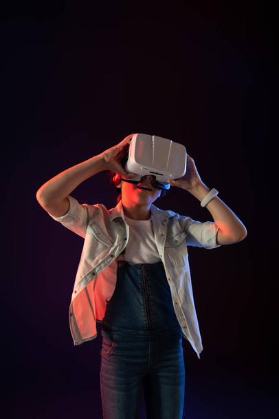 Content girl wearing a VR headset - Фото, изображение