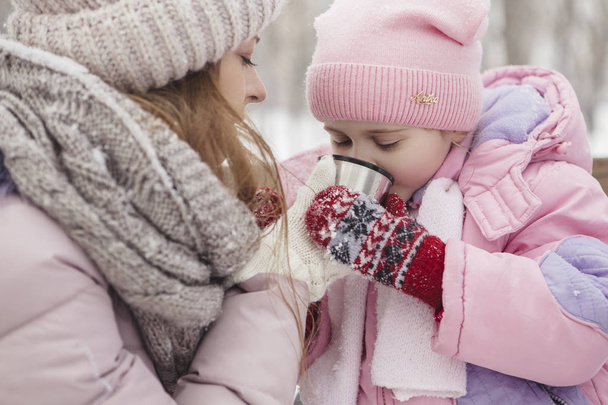 Happy loving caucasian family of mother father and daughter play, having fun in winter snowy park - Foto, imagen
