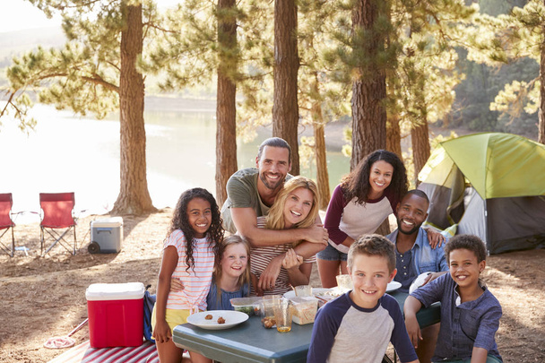 Portrait Of Family With Friends Camping By Lake In Forest - Photo, image