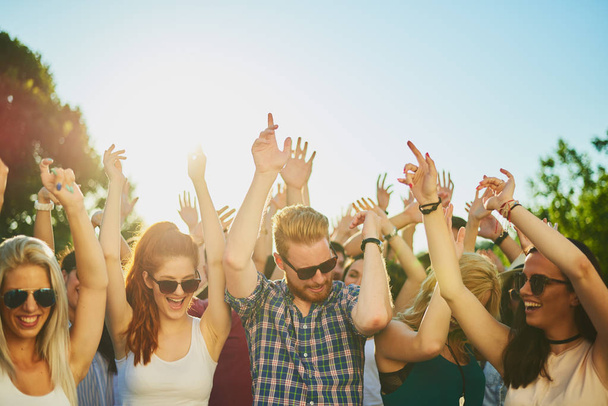Group of people dancing and having a good time at the outdoor party/music festival  - Foto, imagen
