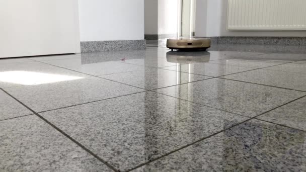 Robotic vacuum cleaner on bright marble floor - Footage, Video