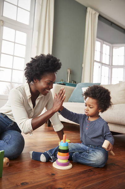Mother Giving Son High Five As Play With Toy At Home - Photo, image