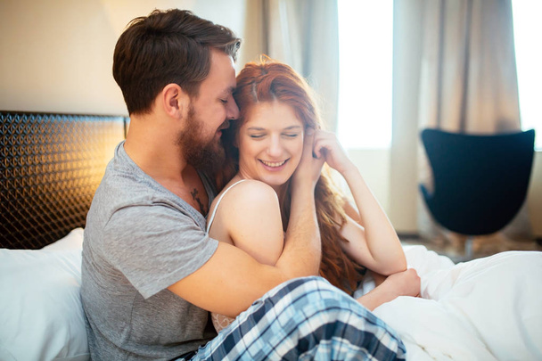 Happy couple in bed showing emotions and love - Φωτογραφία, εικόνα