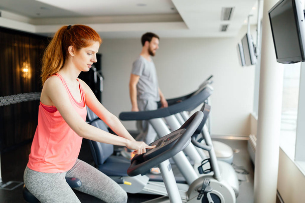 Sportive people cardio exercising in modern gym - Photo, Image