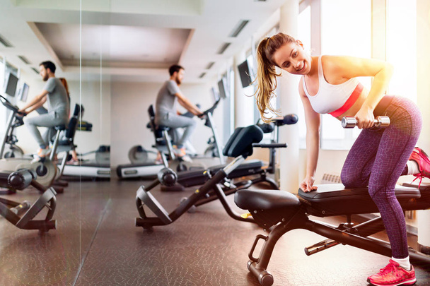Fit beautiful  woman working out in gym - Фото, зображення