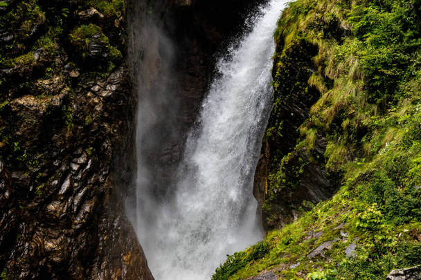 LANDSCAPE VIEW OF A MEDIUM SIZED WATERFALL IN NORTH SIKKIM IN SUMMER - Photo, Image
