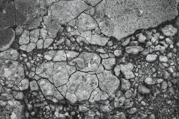 Cracked texture of small gravel stone in a concrete slab cement floor close up - Photo, Image