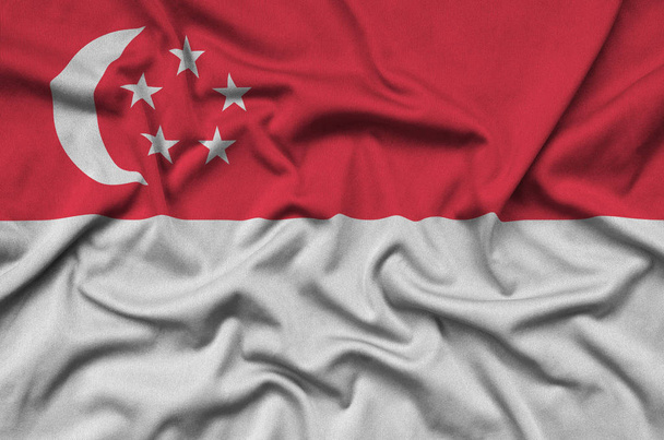 Singapore flag  is depicted on a sports cloth fabric with many folds. Sport team waving banner - Photo, Image