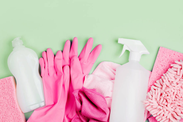 Detergents and cleaning accessories  in pink color.  Cleaning service concept. Flat lay, Top view. - Foto, Imagen