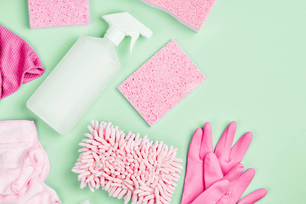 Detergents and cleaning accessories  in pink color.  Cleaning service concept. Flat lay, Top view. - Photo, image
