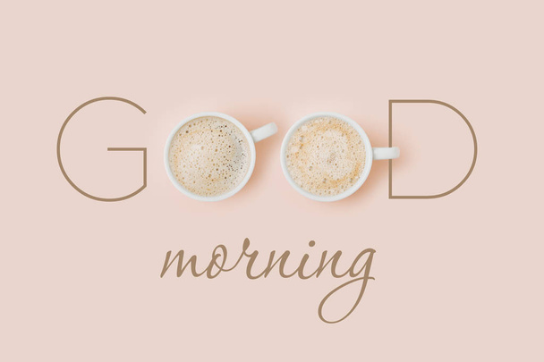 Tarjeta de buena mañana con tazas de café sobre fondo rosa pálido. Piso tendido, vista superior
 - Foto, Imagen