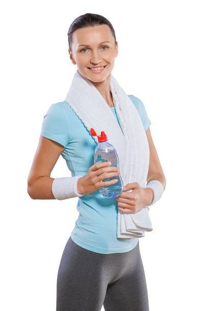a sportswoman with white cotton towel standing smiling holding b - Foto, Bild