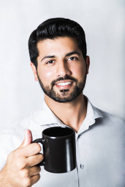 Arabic man in shirt with cup of coffee or tea - Φωτογραφία, εικόνα