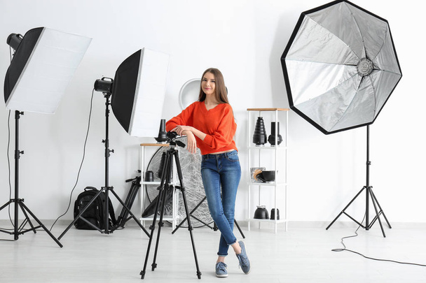 Young female photographer in studio - Zdjęcie, obraz