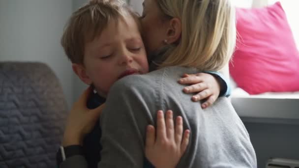 Upset little boy hugging his mother and crying at home - Filmmaterial, Video