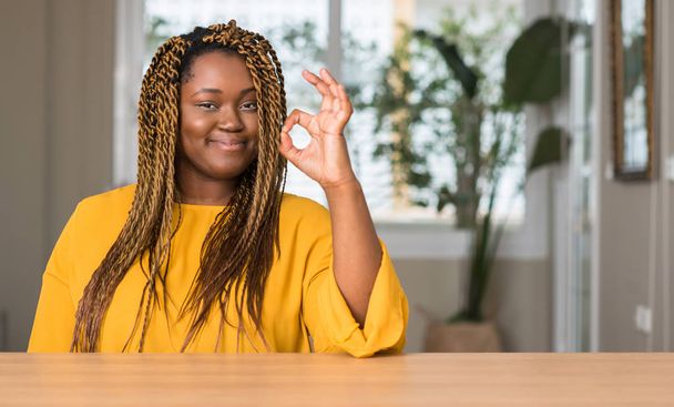 Donna afroamericana a casa facendo ok segno con le dita, simbolo eccellente
 - Foto, immagini