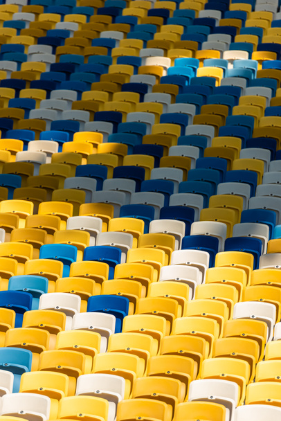 full frame shot of empty colorful seats on tribunes of stadium - Foto, Imagen