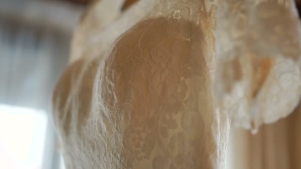 Overview of the white gorgeous wedding dress hanging on the hanger. - Záběry, video