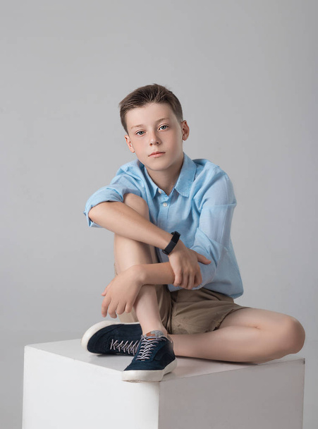 boy posing in fashionable shirt and shirts in studio - Foto, afbeelding