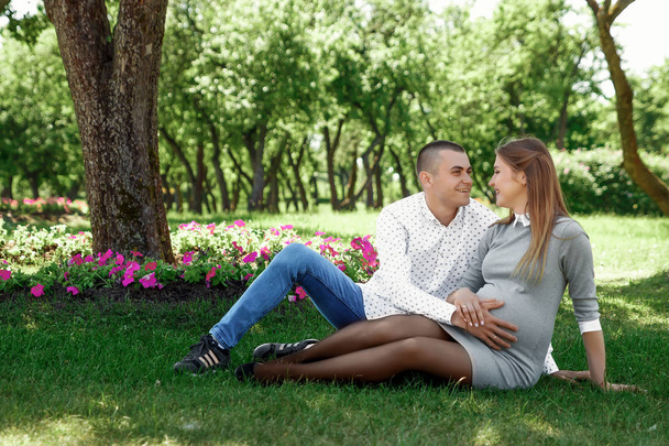 Happy pregnant, married couple in the park. In anticipation of a miracle, a child. Family life, children, pregnancy, family, father, mother. - Photo, Image