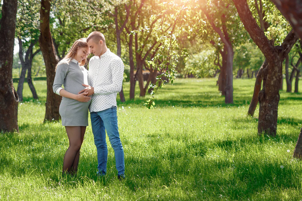 Happy pregnant, married couple in the park. In anticipation of a miracle, a child. Family life, children, pregnancy, family, father, mother. - Fotografie, Obrázek