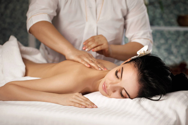 Relaxed woman receiving massage - 写真・画像