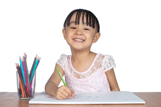 Asian Little Chinese girl painting on paper in isolated white background - Foto, afbeelding