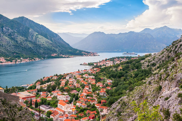Panoramic view from above on the old city Kotor, bay in Adriatic sea and mountains in Montenegro at sunset time, gorgeous nature landscape. - Photo, Image