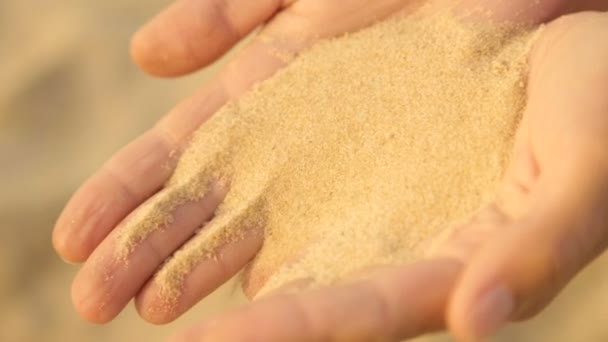 Sea sand is poured from womens hands - Footage, Video